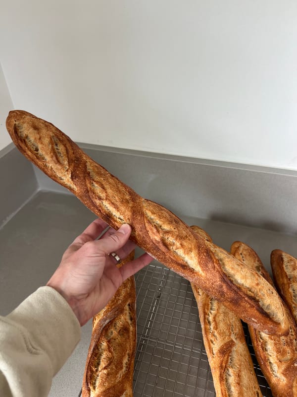 A baguette held up to show the crust
