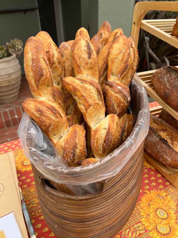 Epi baguettes in a basket at a pop-up